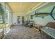 Covered lanai with brick flooring, wicker furniture, and large fish decoration, creating a relaxing outdoor space at 402 12Th Sw St, Ruskin, FL 33570