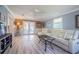 Comfortable living room with bright flooring, recliner seating, and a coffee table at 402 12Th Sw St, Ruskin, FL 33570