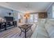 The living room features bright flooring, recliner seating, and access to the patio at 402 12Th Sw St, Ruskin, FL 33570