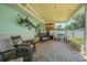 A covered patio featuring wicker seating, brick flooring, and outdoor cooking area at 402 12Th Sw St, Ruskin, FL 33570
