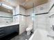 Contemporary bathroom featuring dual shower heads, modern fixtures, and wood paneling at 4291 Neptune Se Dr, St Petersburg, FL 33705