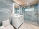 Updated bathroom with stylish blue tiling, glass shower, and wood-paneled ceiling at 4291 Neptune Se Dr, St Petersburg, FL 33705