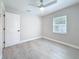 Bright bedroom features light gray walls, white trim, and gray wood-look flooring at 4291 Neptune Se Dr, St Petersburg, FL 33705
