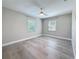 This bedroom has neutral walls, hardwood floors and dual windows at 4291 Neptune Se Dr, St Petersburg, FL 33705