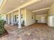 Covered carport with brick flooring, supporting pillars, and space for parking and seating at 4291 Neptune Se Dr, St Petersburg, FL 33705