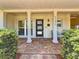 Welcoming front porch with brick flooring, supporting pillars, and green shrubbery at 4291 Neptune Se Dr, St Petersburg, FL 33705