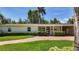 Charming single-story home featuring a brick driveway, lush landscaping, and a welcoming covered entrance at 4291 Neptune Se Dr, St Petersburg, FL 33705