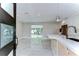 Open kitchen and living area with tiled floors and a modern island at 4291 Neptune Se Dr, St Petersburg, FL 33705