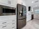 Modern kitchen featuring stainless steel appliances and white cabinets with black hardware at 4291 Neptune Se Dr, St Petersburg, FL 33705