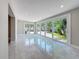 Open living area with sliding glass doors leading to outdoor patio with lush landscaping at 4291 Neptune Se Dr, St Petersburg, FL 33705