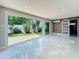 Bright living room with marble floors and sliding glass doors leading to a private backyard at 4291 Neptune Se Dr, St Petersburg, FL 33705
