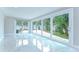 Bright living room with marble tile and sliding glass doors to the backyard at 4291 Neptune Se Dr, St Petersburg, FL 33705