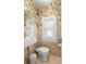 Charming half bathroom featuring whimsical bird wallpaper and neutral stone tiling at 455 18Th Ne Ave, St Petersburg, FL 33704