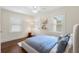 Well-lit bedroom with hardwood floors, a plush bed, and natural light from the windows at 455 18Th Ne Ave, St Petersburg, FL 33704