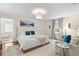 Bright bedroom featuring a white bed, plush carpet, and a cozy sitting area at 455 18Th Ne Ave, St Petersburg, FL 33704