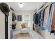 Spacious walk-in closet with custom shelving, a fluffy area rug, and a comfortable chair at 455 18Th Ne Ave, St Petersburg, FL 33704
