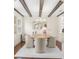 Elegant dining room with a round table, comfortable seating, striking ceiling beams, and a modern chandelier at 455 18Th Ne Ave, St Petersburg, FL 33704