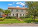 Charming two-story home with a tile roof, manicured lawn, and lush landscaping at 455 18Th Ne Ave, St Petersburg, FL 33704