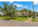 Beautiful home featuring manicured landscaping, mature trees, and a charming brick street at 455 18Th Ne Ave, St Petersburg, FL 33704