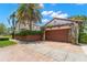 Detached garage with a wooden door and brick driveway, complemented by lush landscaping and a charming curb appeal at 455 18Th Ne Ave, St Petersburg, FL 33704