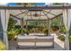 Relaxing gazebo with comfortable seating, featuring a ceiling fan and wind chimes, overlooking a lush backyard with a fountain at 455 18Th Ne Ave, St Petersburg, FL 33704