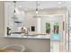 Bright kitchen with quartz countertops, stainless steel appliances, and view to the pool area at 455 18Th Ne Ave, St Petersburg, FL 33704