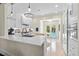 Bright, all-white kitchen with sleek countertops, stainless steel appliances, and doors opening to the pool area at 455 18Th Ne Ave, St Petersburg, FL 33704