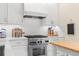 Modern kitchen with stainless steel range, custom cabinetry, stylish countertops, and ample natural light at 455 18Th Ne Ave, St Petersburg, FL 33704
