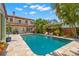Beautiful backyard pool with lounge chairs, mature trees, and a Mediterranean-style home at 455 18Th Ne Ave, St Petersburg, FL 33704