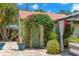 Pool house with a charming green door surrounded by lush greenery, offering a private entrance to the backyard oasis at 455 18Th Ne Ave, St Petersburg, FL 33704
