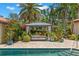 Beautiful backyard pool area featuring a gazebo with comfortable seating, lush landscaping, and a serene atmosphere at 455 18Th Ne Ave, St Petersburg, FL 33704