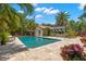 Backyard oasis with a sparkling pool, cabana, and tropical landscaping at 455 18Th Ne Ave, St Petersburg, FL 33704