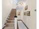 Traditional staircase featuring carpeted steps, a white banister and neutral-painted walls at 455 18Th Ne Ave, St Petersburg, FL 33704