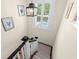 Bright stairway leading to a lower level, illuminated by a window and pendant lighting at 455 18Th Ne Ave, St Petersburg, FL 33704