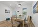 Bright dining room featuring modern light fixture, table for six, and stylish décor with view to outdoor at 461 Celeste St, Port Charlotte, FL 33954