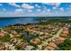 Scenic aerial view showcasing a charming residential area with a tranquil lake and tree-lined streets at 4611 Grand Preserve Pl, Palm Harbor, FL 34684