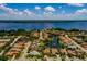 Panoramic aerial shot showcases a neighborhood near a large lake, featuring homes with tile roofs and serene water views at 4611 Grand Preserve Pl, Palm Harbor, FL 34684