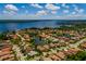 Stunning aerial view of a waterfront home featuring lush landscaping and community lake access at 4611 Grand Preserve Pl, Palm Harbor, FL 34684