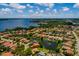 Overhead shot of a lovely suburb featuring a central pond, well-maintained homes, and a beautiful skyline at 4611 Grand Preserve Pl, Palm Harbor, FL 34684