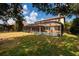 A fenced yard features a private pool, an outdoor lanai, and lush lawn at 4611 Grand Preserve Pl, Palm Harbor, FL 34684