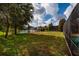 The backyard features a beautiful view of the neighborhood lake and the manicured lawn at 4611 Grand Preserve Pl, Palm Harbor, FL 34684