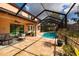 Inviting backyard pool, screened-in lanai, and patio for relaxing and outdoor enjoyment at 4611 Grand Preserve Pl, Palm Harbor, FL 34684