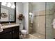 A bathroom featuring a glass-enclosed shower, granite-topped vanity, and neutral color scheme at 4611 Grand Preserve Pl, Palm Harbor, FL 34684