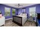 Charming purple bedroom with ample natural light and a cozy atmosphere at 4611 Grand Preserve Pl, Palm Harbor, FL 34684
