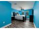 Bright blue bedroom with wood floors and a ceiling fan offers a comfortable space at 4611 Grand Preserve Pl, Palm Harbor, FL 34684