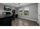 Simple bedroom with wood floors and a ceiling fan, perfect for sleeping or gaming at 4611 Grand Preserve Pl, Palm Harbor, FL 34684