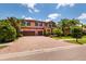 Appealing two-story home featuring a brick driveway, two-car garage, and mature landscaping at 4611 Grand Preserve Pl, Palm Harbor, FL 34684