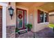 Inviting front entryway with a decorative glass door, red wreath, and brick-paved porch at 4611 Grand Preserve Pl, Palm Harbor, FL 34684