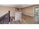 Hallway with wood floors leading to bedrooms and views of the downstairs area at 4611 Grand Preserve Pl, Palm Harbor, FL 34684