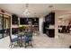 Modern kitchen with dark cabinetry, granite countertops, stainless steel appliances, and breakfast bar seating at 4611 Grand Preserve Pl, Palm Harbor, FL 34684